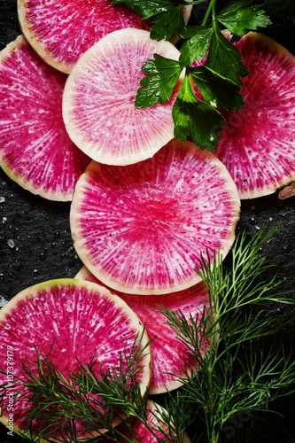 Food background: round slices of watermelon pink radish, dill, p