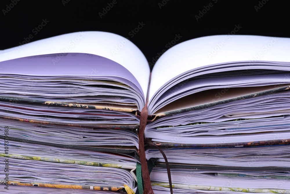 Stack of notebooks on black background Stack of notebooks on black background
