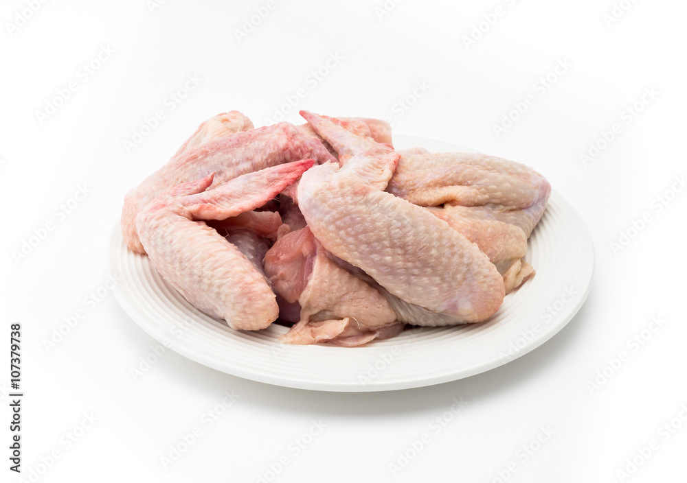Raw chicken wings on a plate isolated on white background Raw chicken wings on a plate isolated on white background