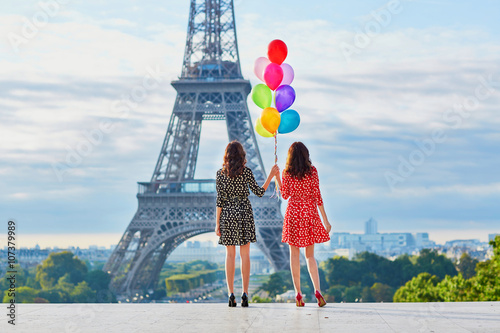 Beautiful twin sisters with colorful balloons © Ekaterina Pokrovsky