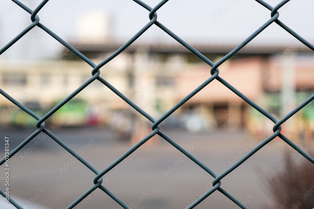 Steel Grating grid on blur city background Steel Grating grid on blur city background