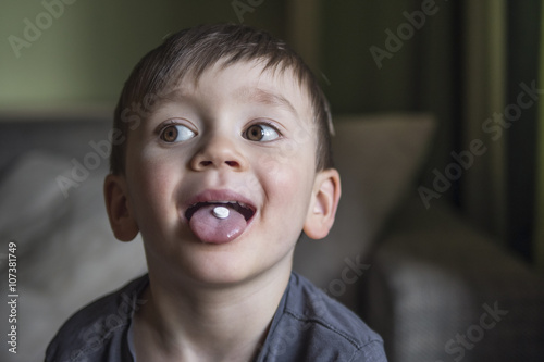 small kid taking medicine