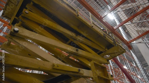 Scissor Lift work inside a new modern warehouse