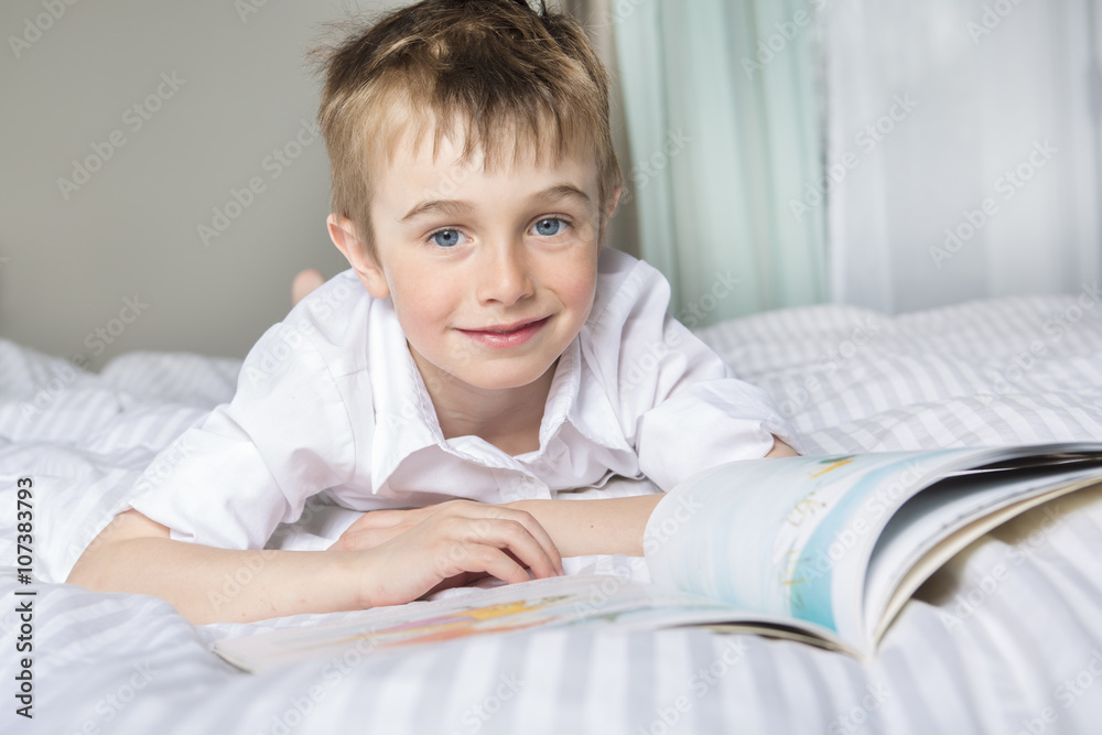 little boy reading before dream in his bed little boy reading before dream in his bed