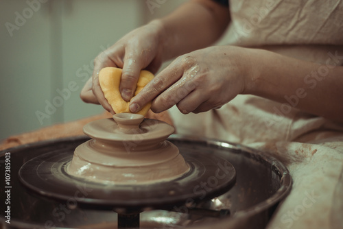 child working on potter's wheel