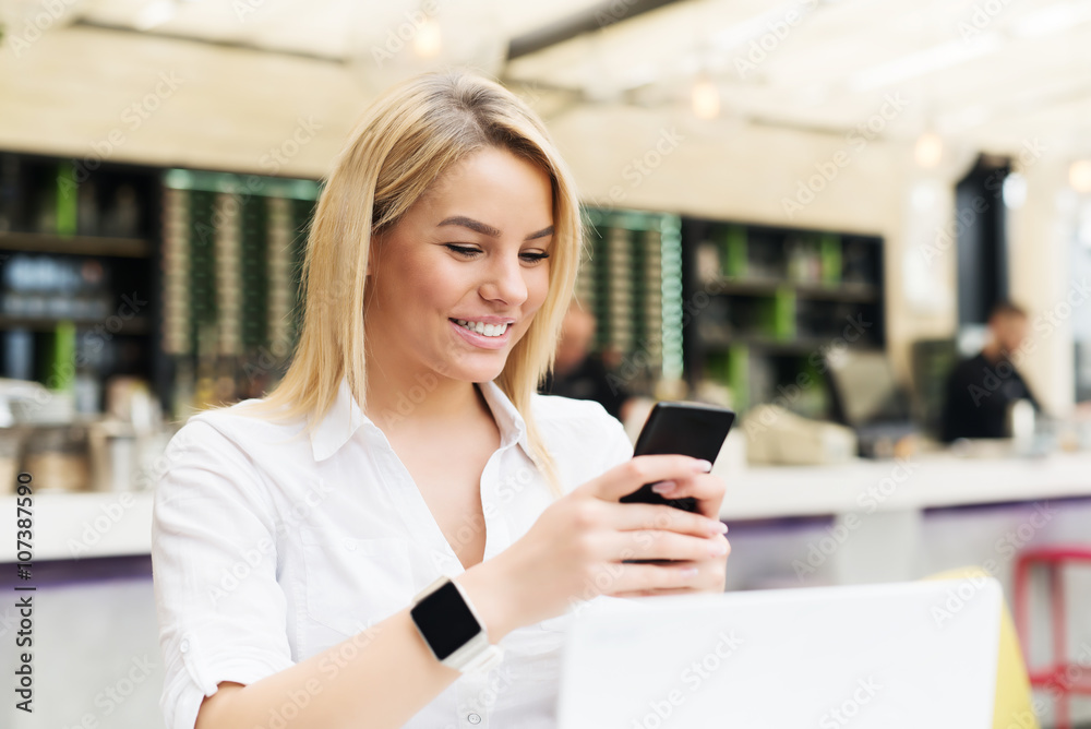 Attractive female typing message at smart phone. Attractive female typing message at smart phone.