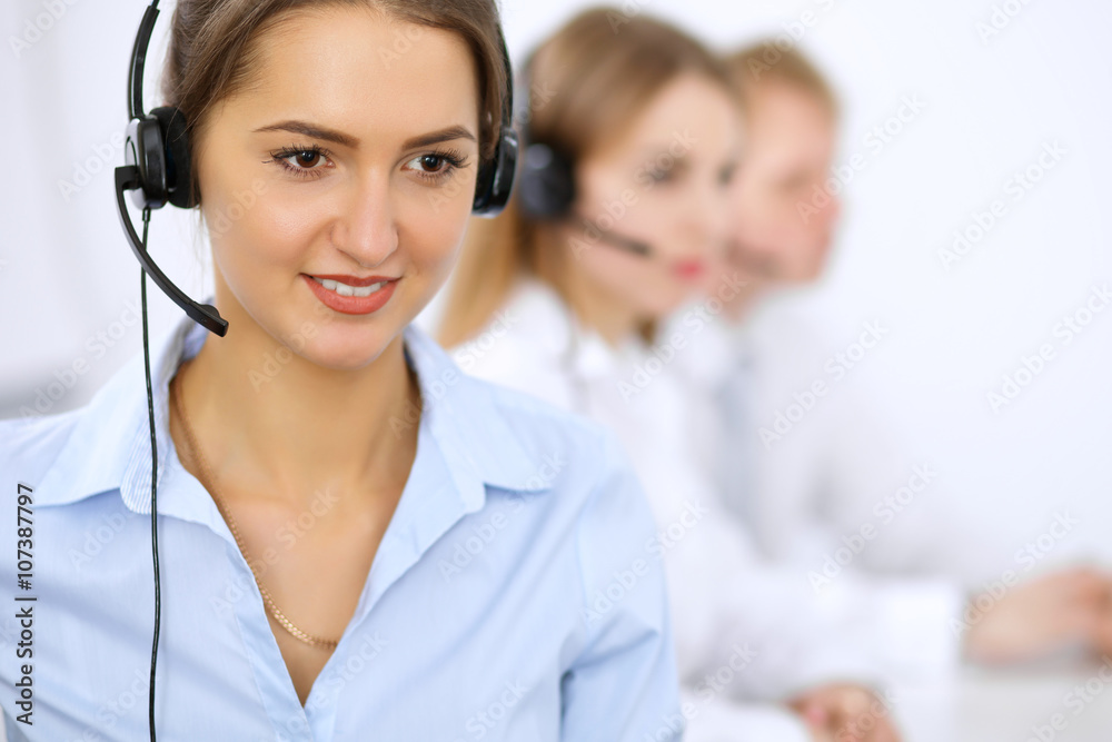 Call center. Focus on beautiful woman in headset Call center. Focus on beautiful woman in headset