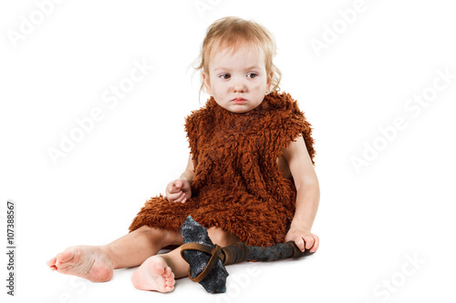 Photos Funny boy caveman in a suit with dirty face holding an ax.