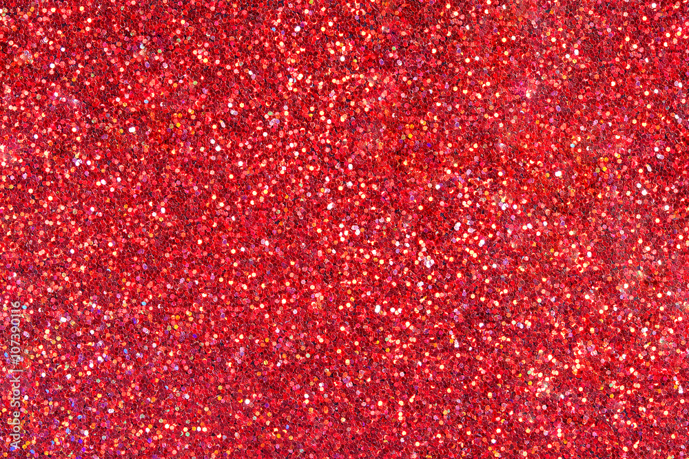 Red glitter texture close-up as a background.
