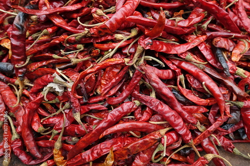 close up of dried red chillies in a pan.