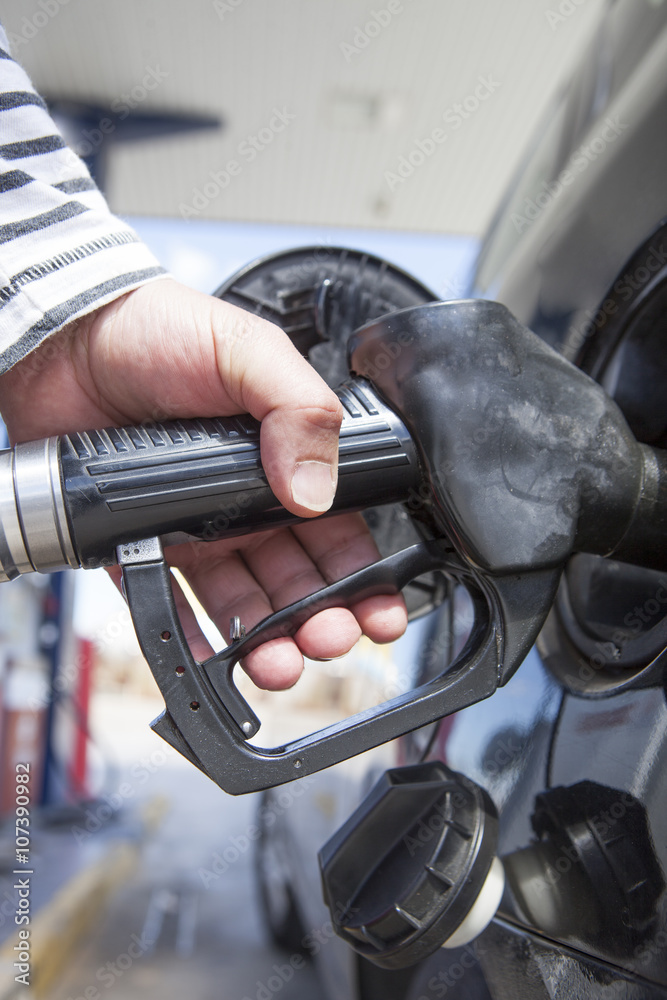 Man pumping gasoline fuel in car