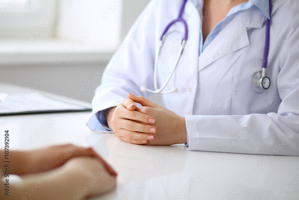 Doctor and patient are discussing something, just hands at the table