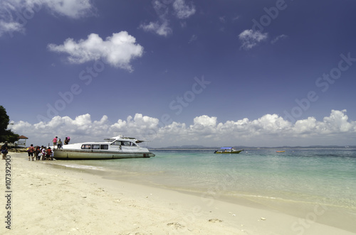 White ferry anchored and waiting for tourists returning to the mainland.Kapas Island or Cotton island, a name given by local due to  beautiful white beaches and it is designated marine park. © amirul syaidi