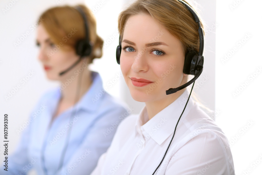 Call center. Focus on beautiful woman in headset Call center. Focus on beautiful woman in headset