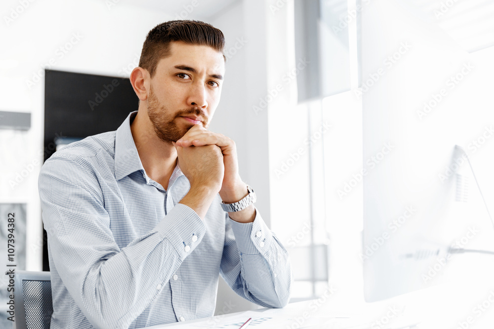 Male office worker sitting at desk