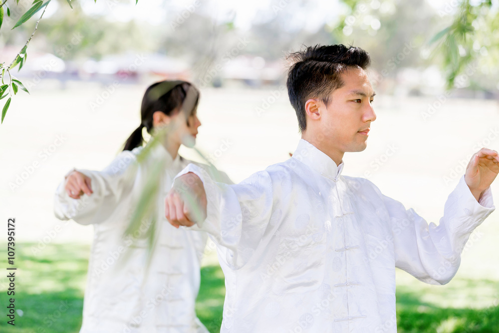People practicing thai chi in park People practicing thai chi in park