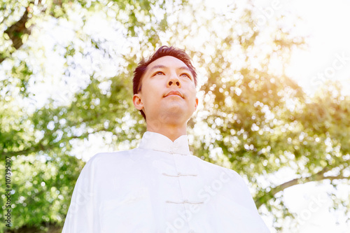 Handsome man practicing thai chi
