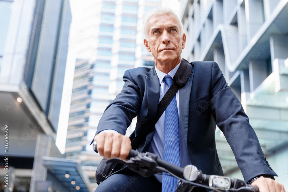 Successful businessman riding bicycle Successful businessman riding bicycle