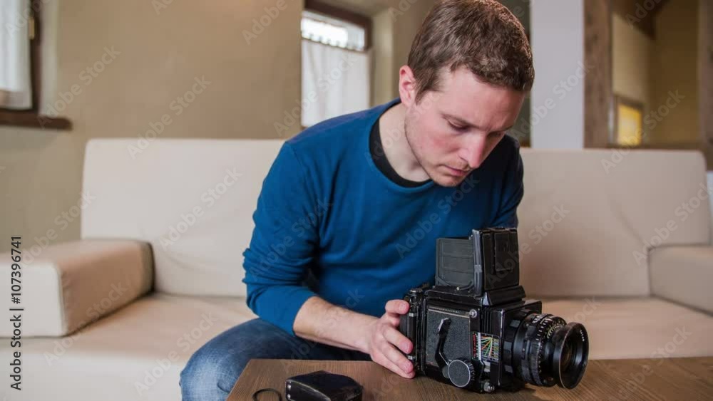 Man holding retro camera on table Man holding retro camera on table