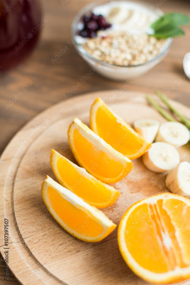 Healthy and wholesome breakfast. Sliced ​​oranges on wooden