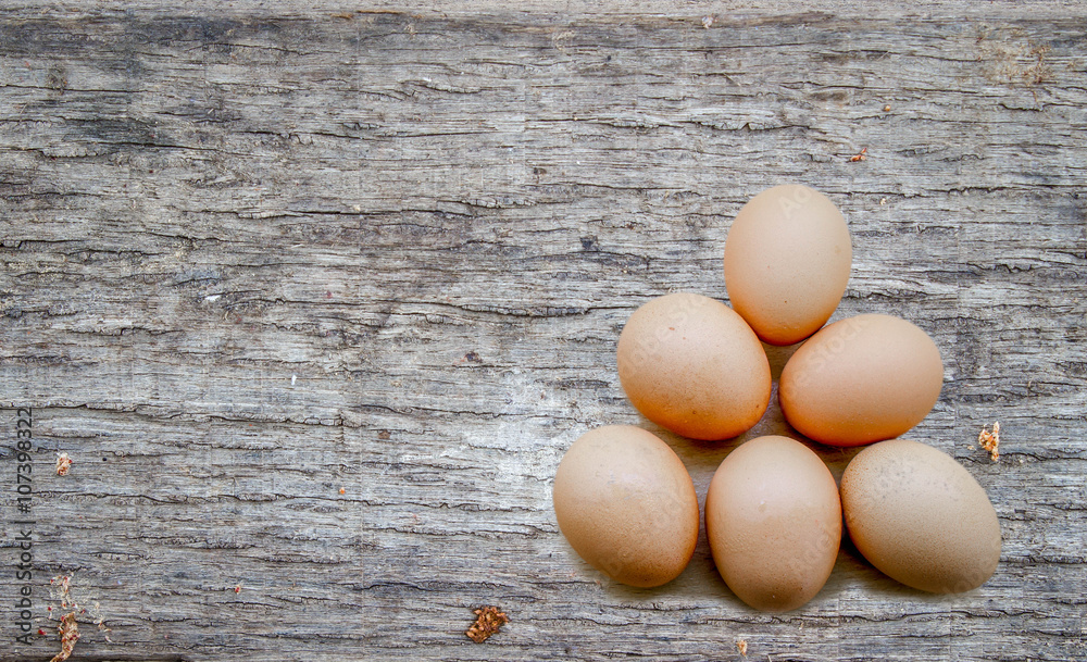 fresh eggs on wood background