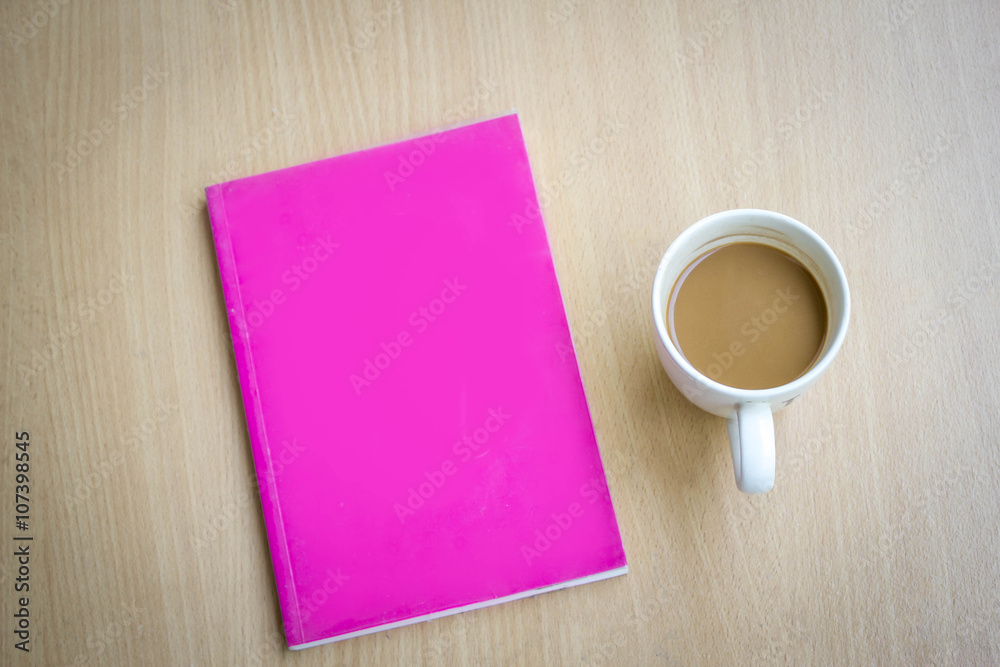 hot coffee in old white cup with pink cover book