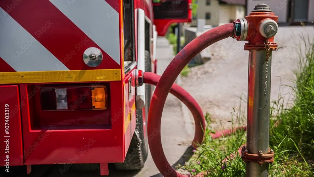 Firetruck filling from hydrant close up Firetruck filling from hydrant close up