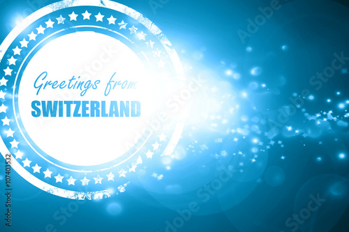 Blue stamp on a glittering background: Greetings from switzerlan