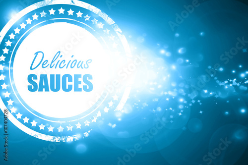 Blue stamp on a glittering background: Delicious sauces sign