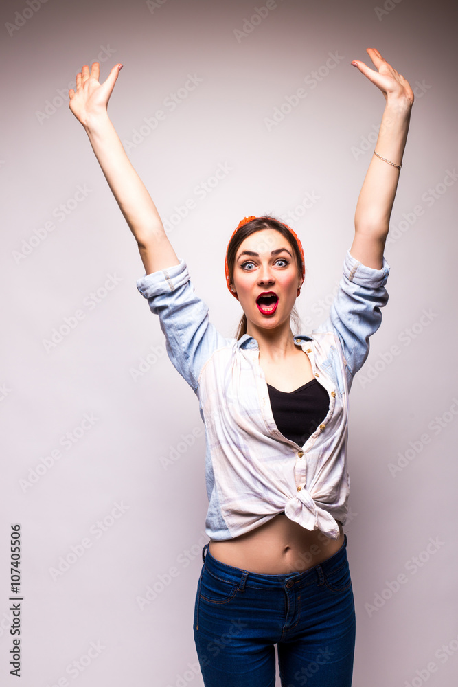 Portrait of a young woman standing, hand up and scream on white background Portrait of a young woman standing, hand up and scream on white background