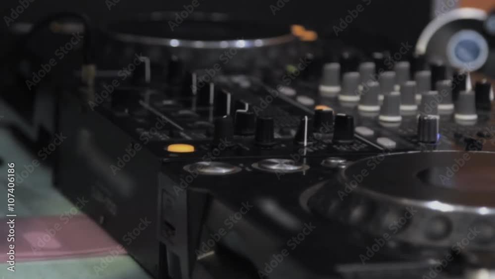 Dj playing and mixing music in a night club