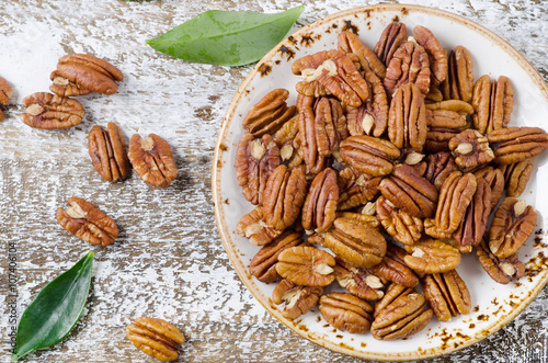 Pecans  on wooden table.