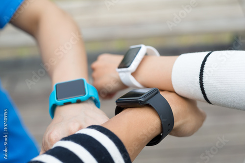Friends using smart watch together © leungchopan