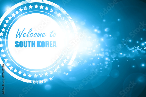 Blue stamp on a glittering background: Welcome to south korea
