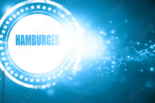 Blue stamp on a glittering background: Delicious hamburger sign