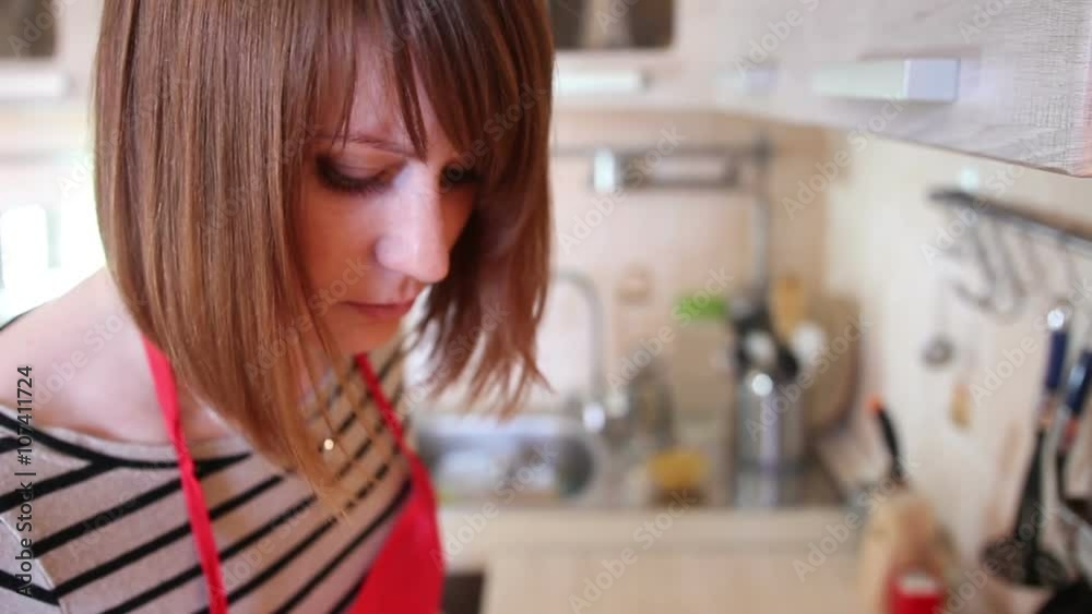 Young woman is cooking in the kitchen Young woman is cooking in the kitchen