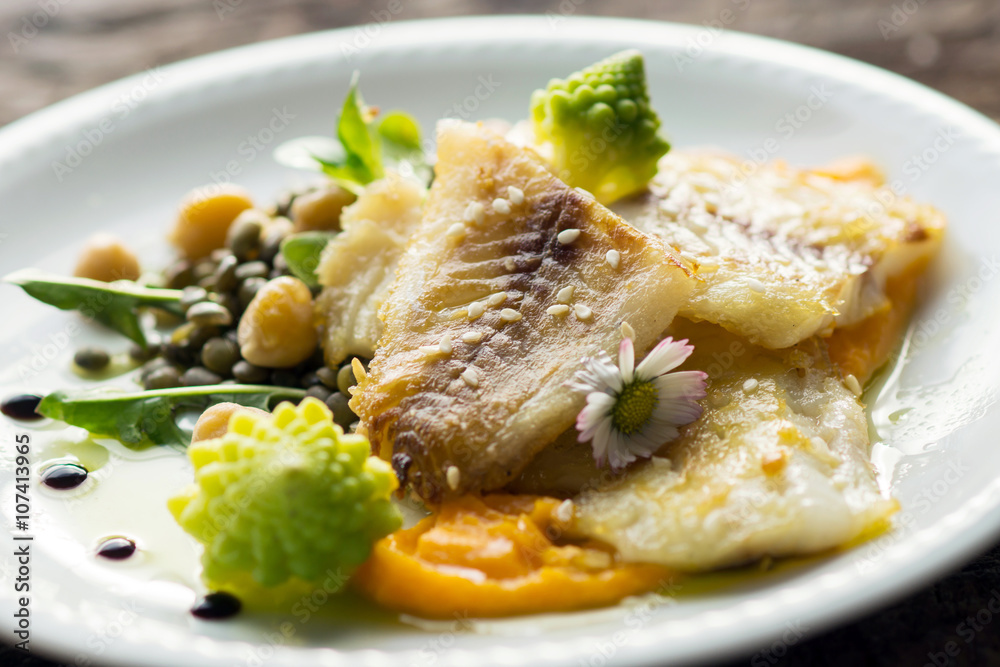 Fish fillet with chickpeas, carrot puree and vegetables