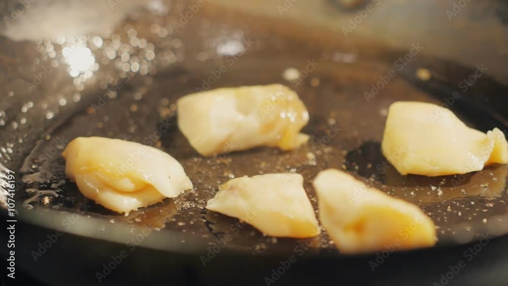 Scallops fried in hot skillet