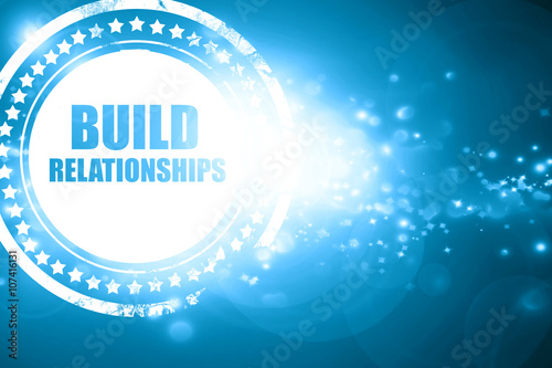 Blue stamp on a glittering background: build relationships