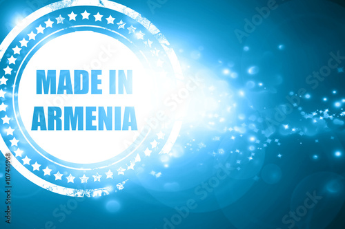 Blue stamp on a glittering background: Made in armenia