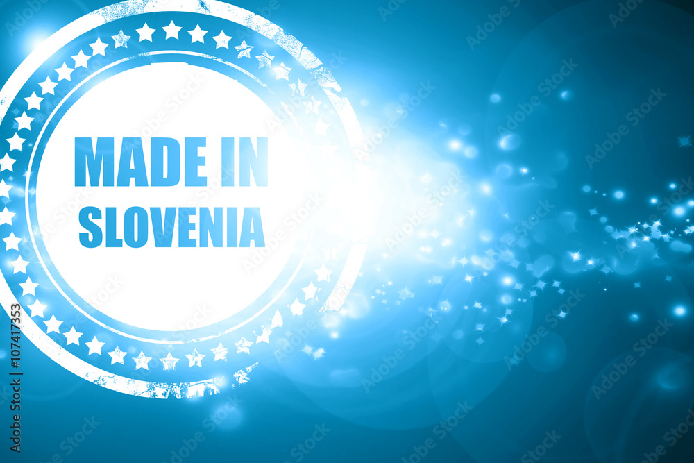 Blue stamp on a glittering background: Made in slovenia