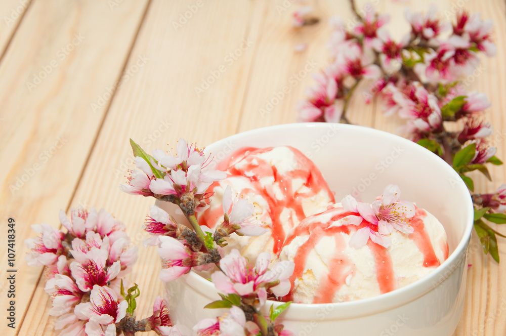 Vanilla ice cream with cherry on wooden background