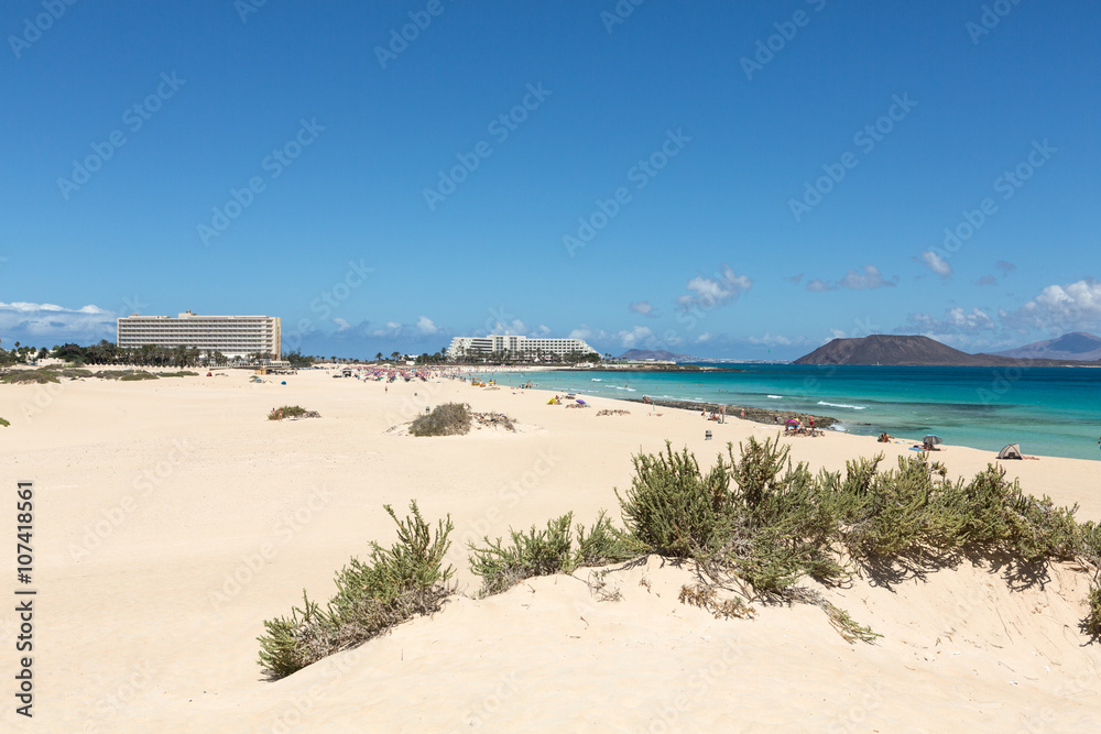 Tourists rest on Corralejo Beach on Fuerteventura, Canary Islands