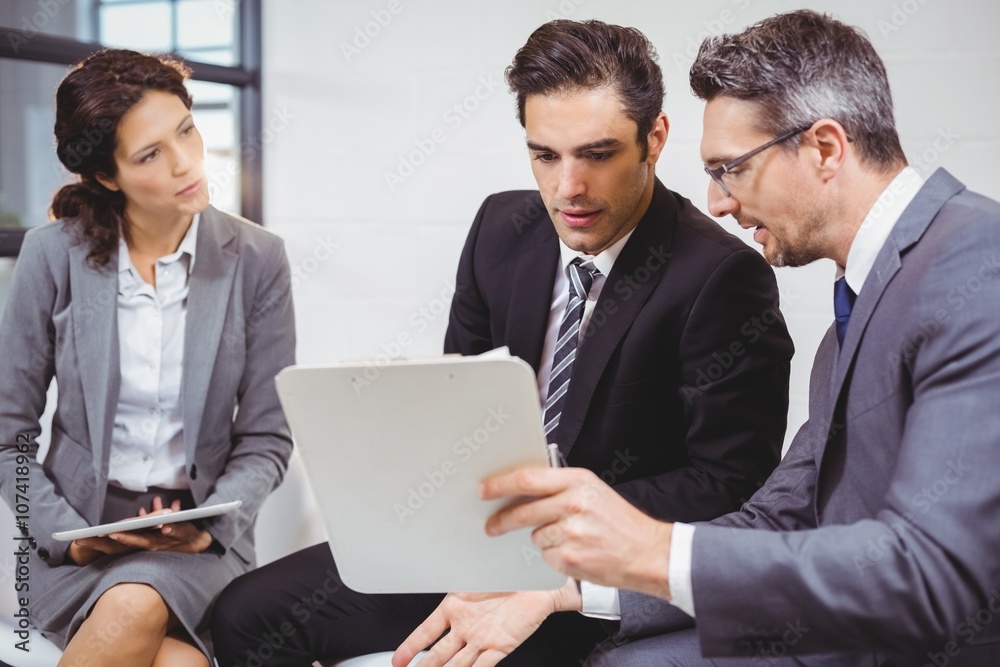 Business professionals holding documents on clipboard Business professionals holding documents on clipboard