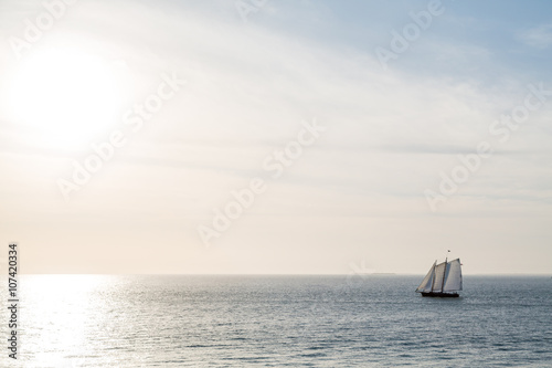 Three Masts Sailing Toward Sunset