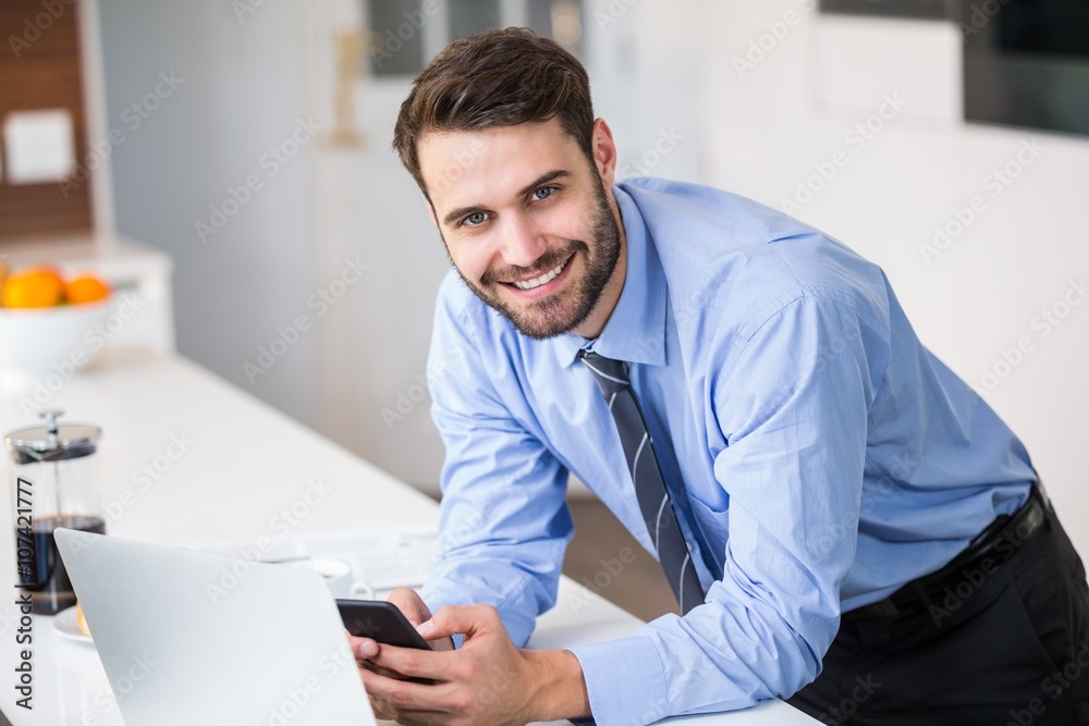 Businessman using mobile phone at home Businessman using mobile phone at home