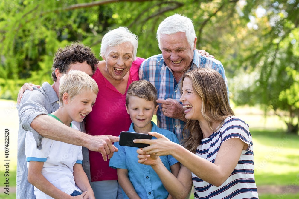 Smiling family using smartphone