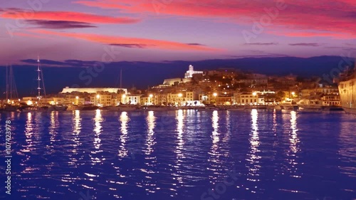 Ibiza Eivissa town sunset with city lights reflection in Mediterranean sea of balearic Islands of Spain photo