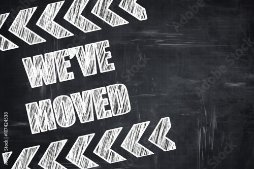 Chalkboard writing: We've moved sign