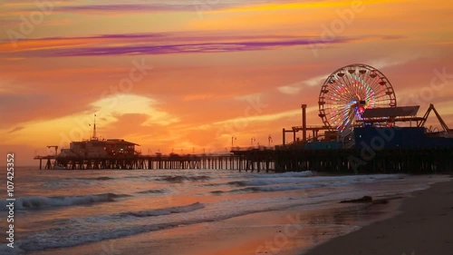 Santa Monica California sunset on Pier Ferris wheel and reflection on beach wet sand